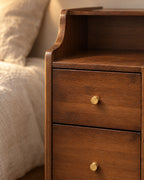 Close-up detail of the slim walnut-finish bamboo bedside table