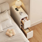 Slim cream bedside table with both drawers open beside a bed