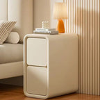 Slim cream bedside table with two handle-free drawers beside a bed