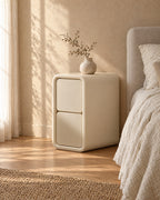 Three-quarter view of the slim cream bedside table showing its 40 cm depth