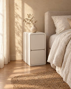 Three-quarter view of the slim legless cream bedside table