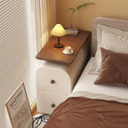 Front view of the slim cream bedside table with walnut-effect top and two drawers with wooden knobs