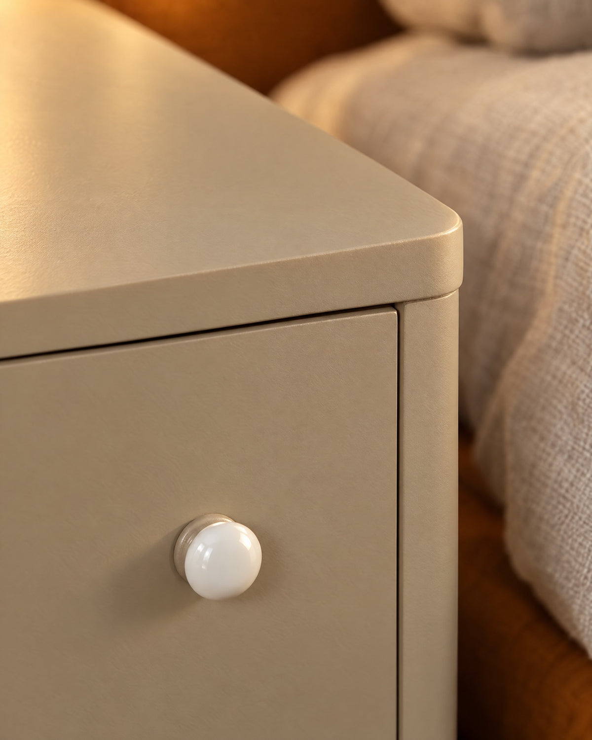 Close-up detail of the slim greige bedside table with open shelf