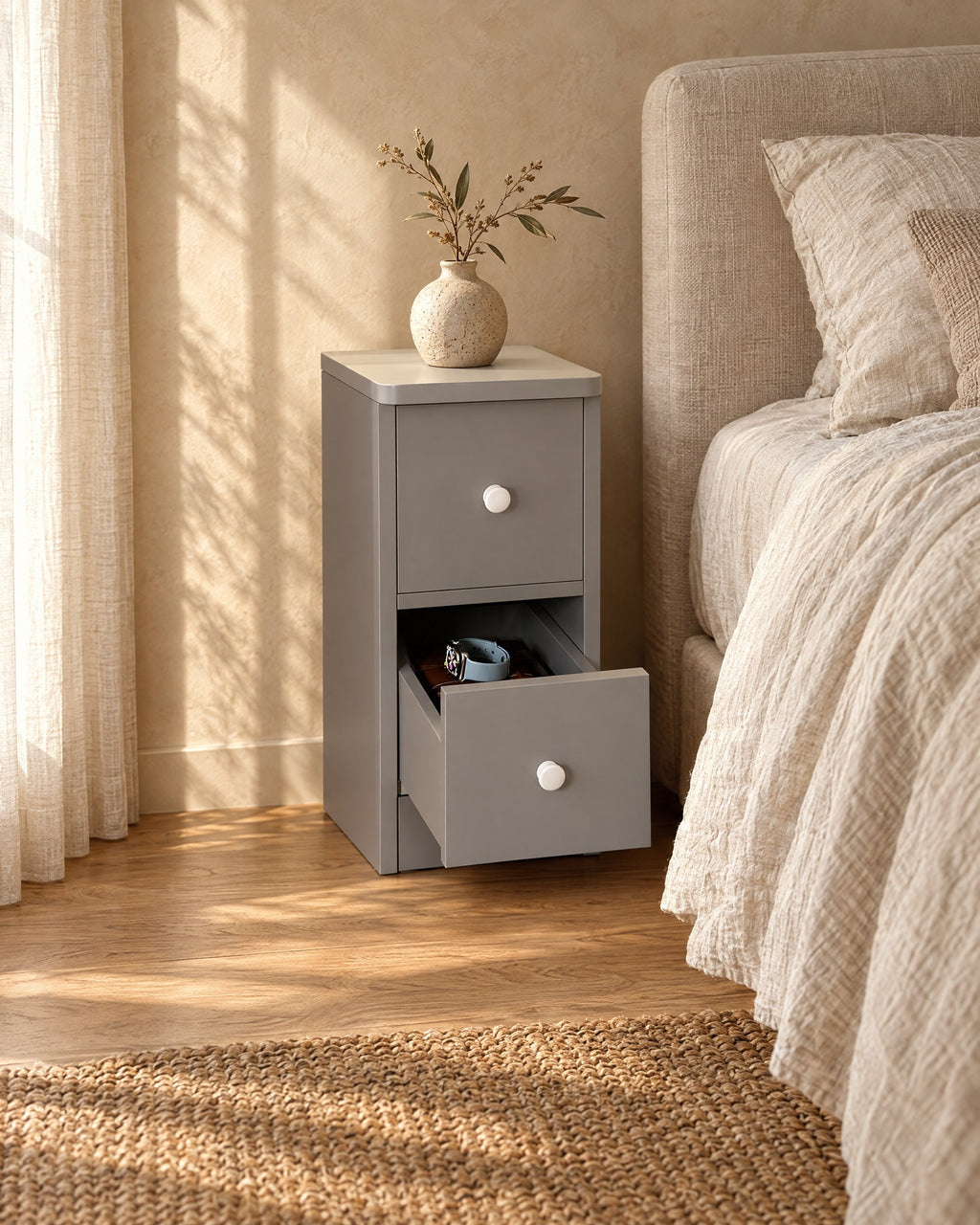 Three-quarter view of the slim grey bedside table