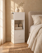 Three-quarter view of the slim white bedside table showing the side book niche