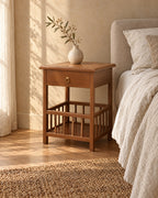 Three-quarter view of the bamboo bedside table showing the spindle gallery shelf