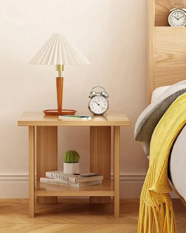 Small oak-effect bedside table with a lamp and books on the lower shelf