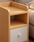 Close-up of the rounded oak side panel and the white drawer knob