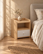 Three-quarter view of the small oak and white bedside table