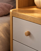 Close-up detail of the tall oak-effect bedside table with bookcase