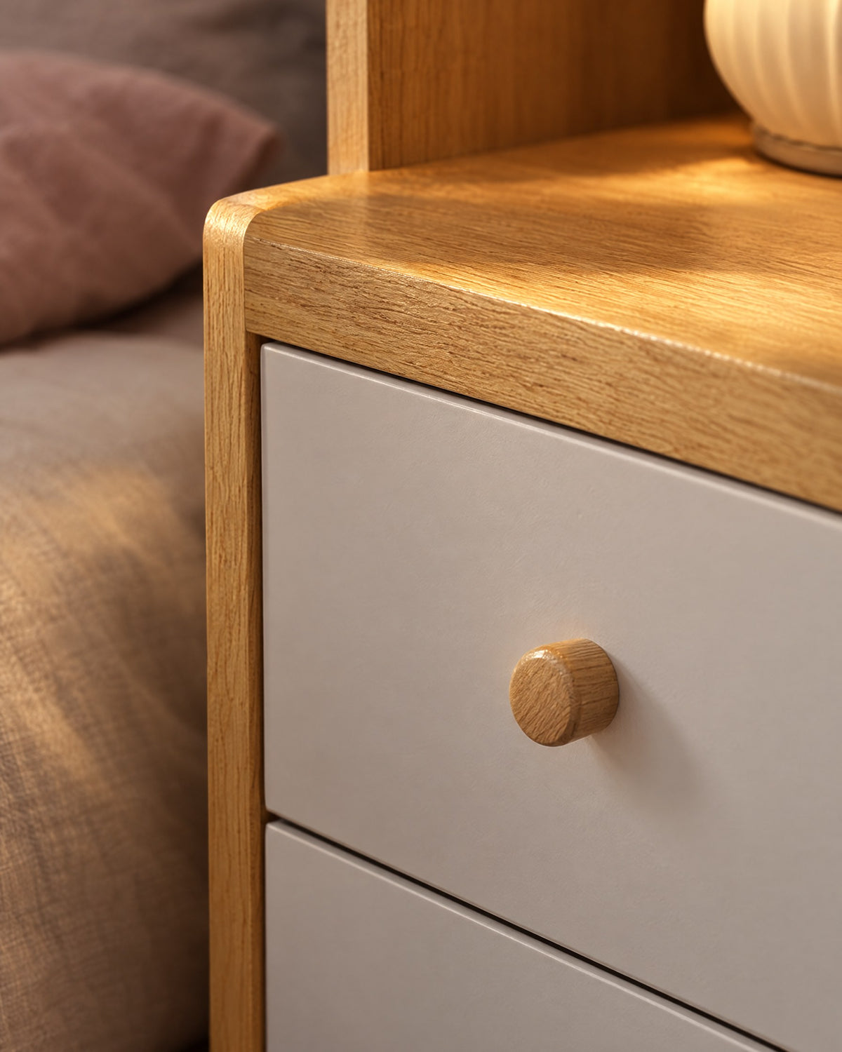 Close-up detail of the tall oak-effect bedside table with bookcase