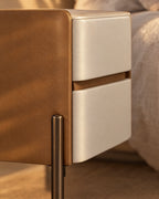 Close-up of the ivory drawer fronts and the tan faux-leather frame