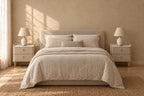 Pair of taupe bedside tables with stone tops on each side of a double bed