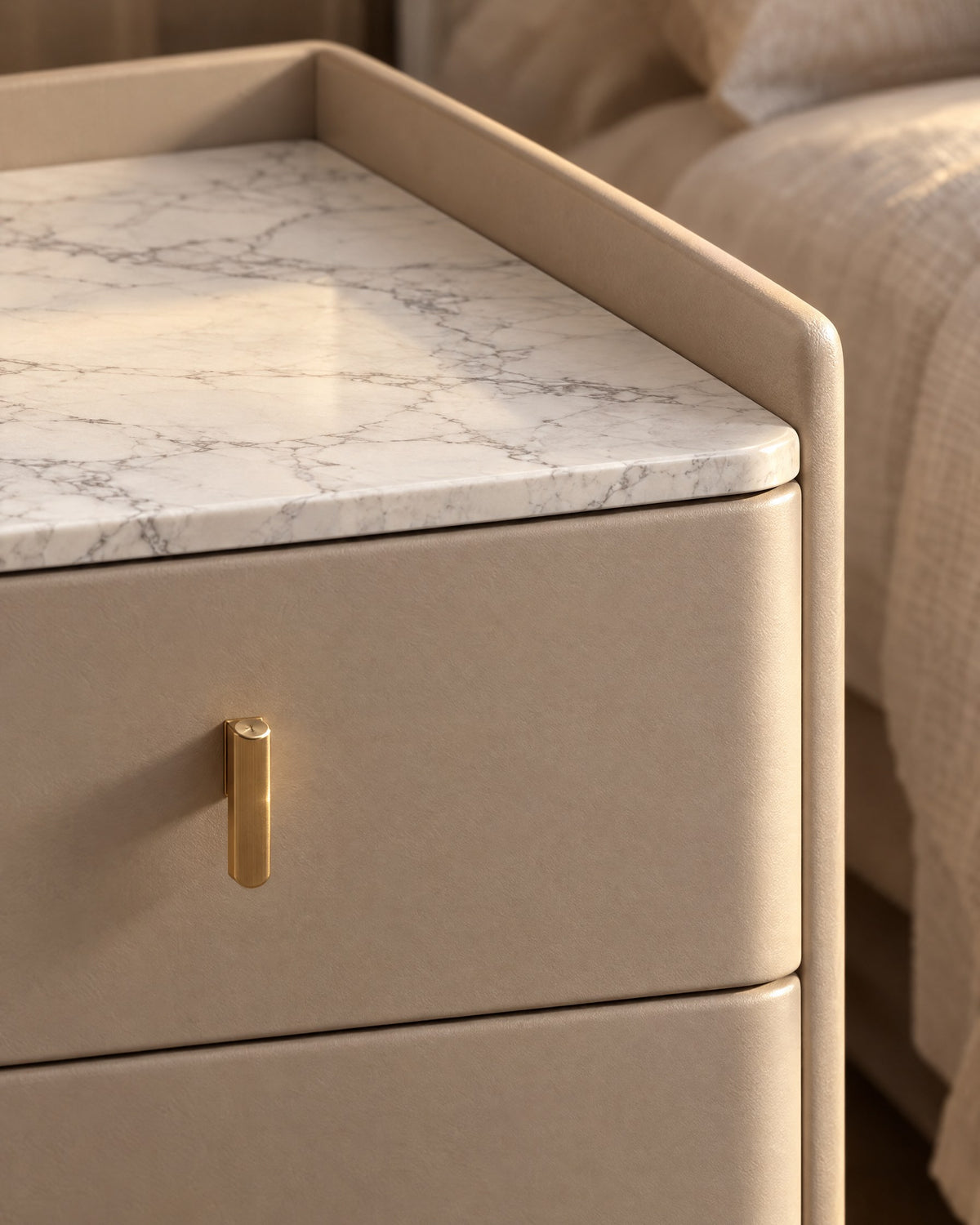 Close-up of the marble-look stone top, raised lip and gold drawer pull