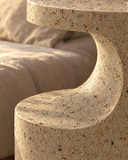 Close-up of the speckled terrazzo-look finish where the curved cut-out meets the lower round tier