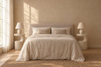 Pair of terrazzo-look round sculpted bedside tables on each side of a double bed