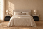 Pair of two-tier greige and black bedside tables on each side of a double bed