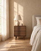 Walnut bedside table with rounded corners in morning light