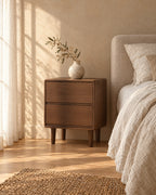 Three-quarter view of the walnut bedside table showing the short wooden legs