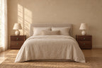 Pair of walnut bedside tables with a fluted drawer and clover knobs on each side of a double bed