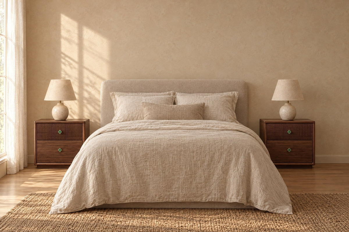 Pair of walnut bedside tables with a fluted drawer and clover knobs on each side of a double bed