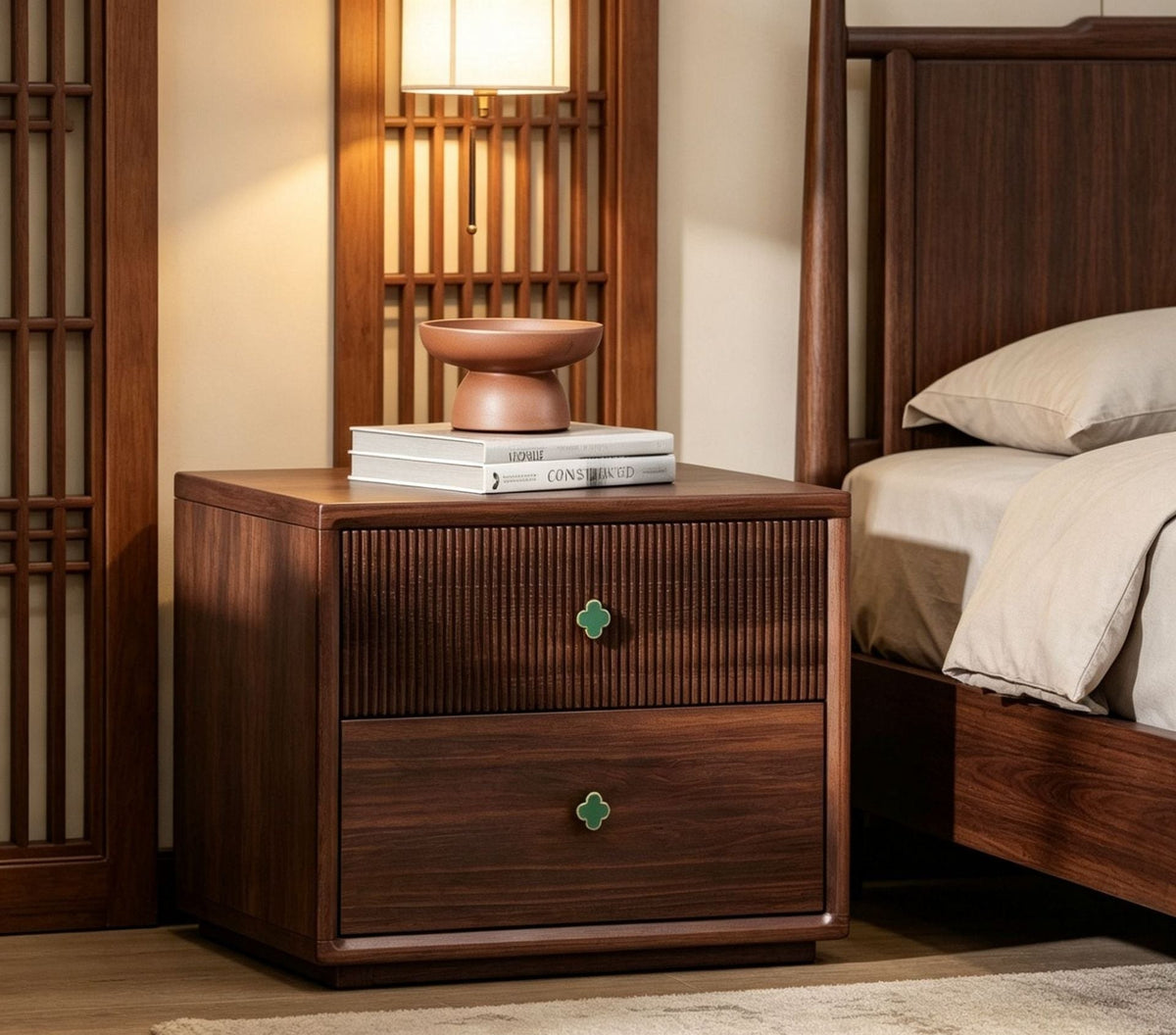 Walnut bedside table with a fluted drawer and clover knobs in a bedroom