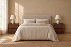 Pair of walnut bedside tables with black tops on each side of a double bed