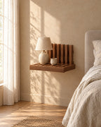 Walnut fold-down wall bedside shelf with a ceramic lamp in warm morning light