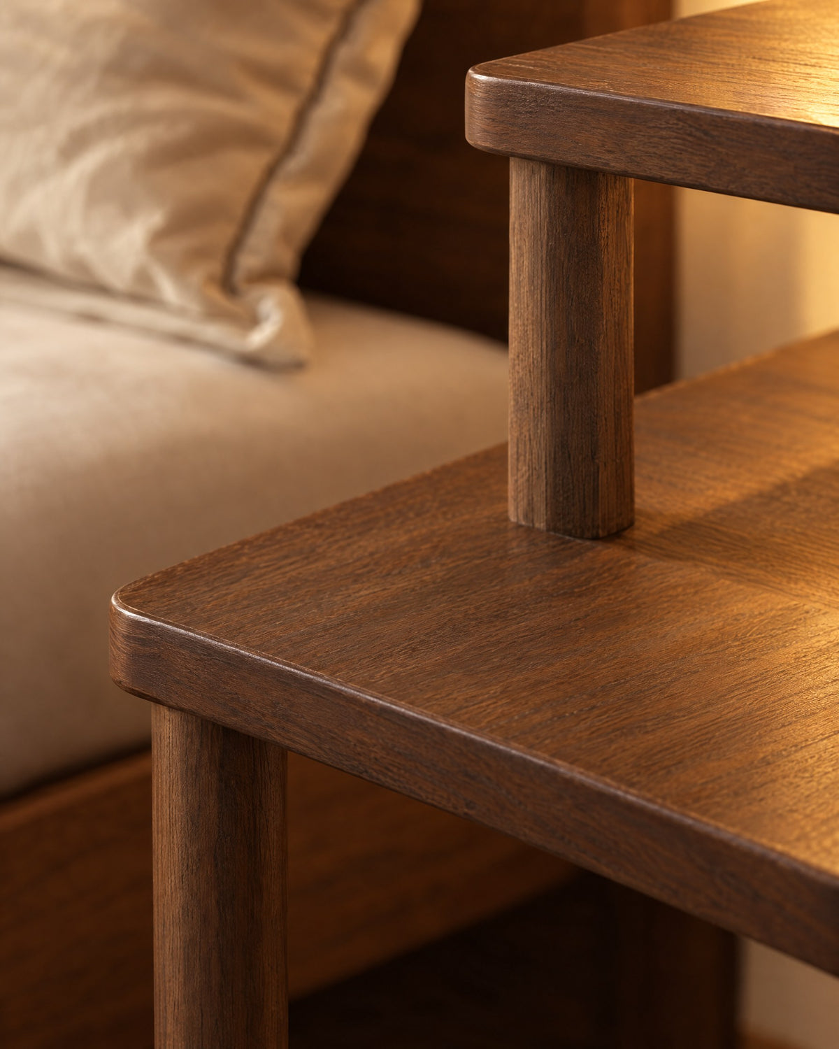 Close-up of the walnut tabletop corner, round leg and raised shelf post