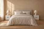Pair of white bedside table with a curved finger pulls either side of a double bed