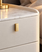 Close-up of the gold drawer handle and the marble-effect stone top