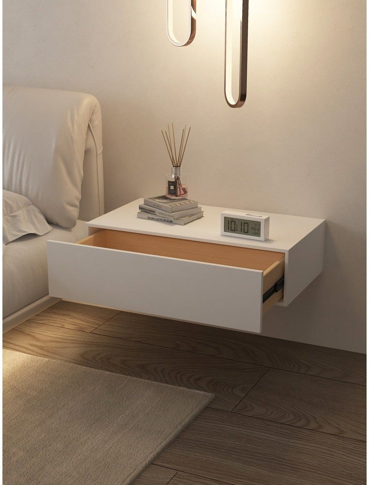 White floating bedside table with keypad lock in a bedroom