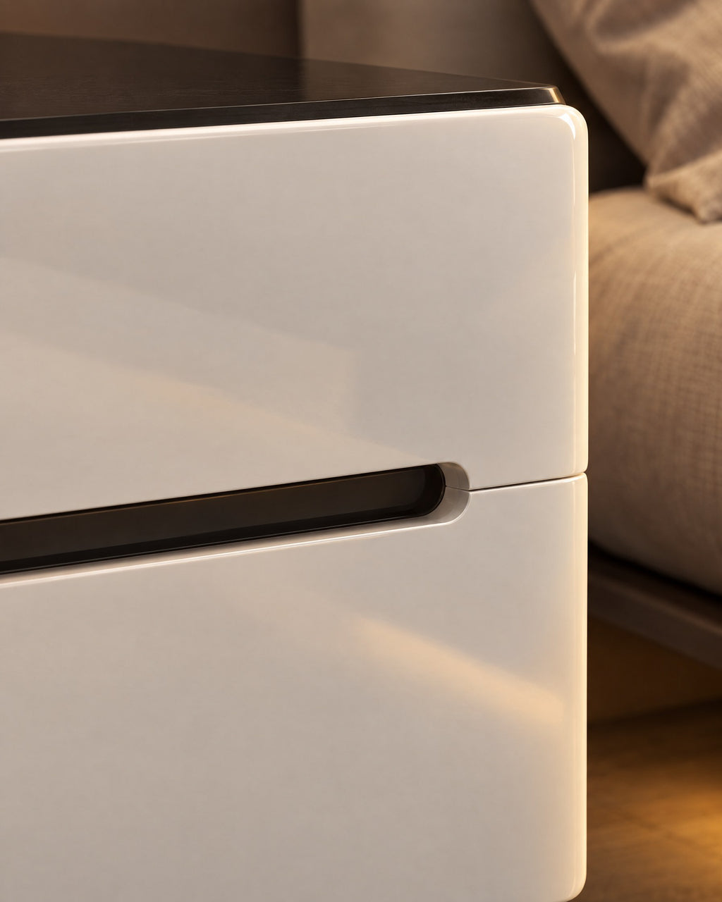 Close-up of the long black slot handle and the glossy white drawer fronts