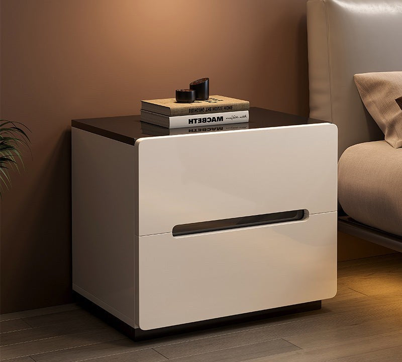 White gloss bedside table with a black top in a bedroom