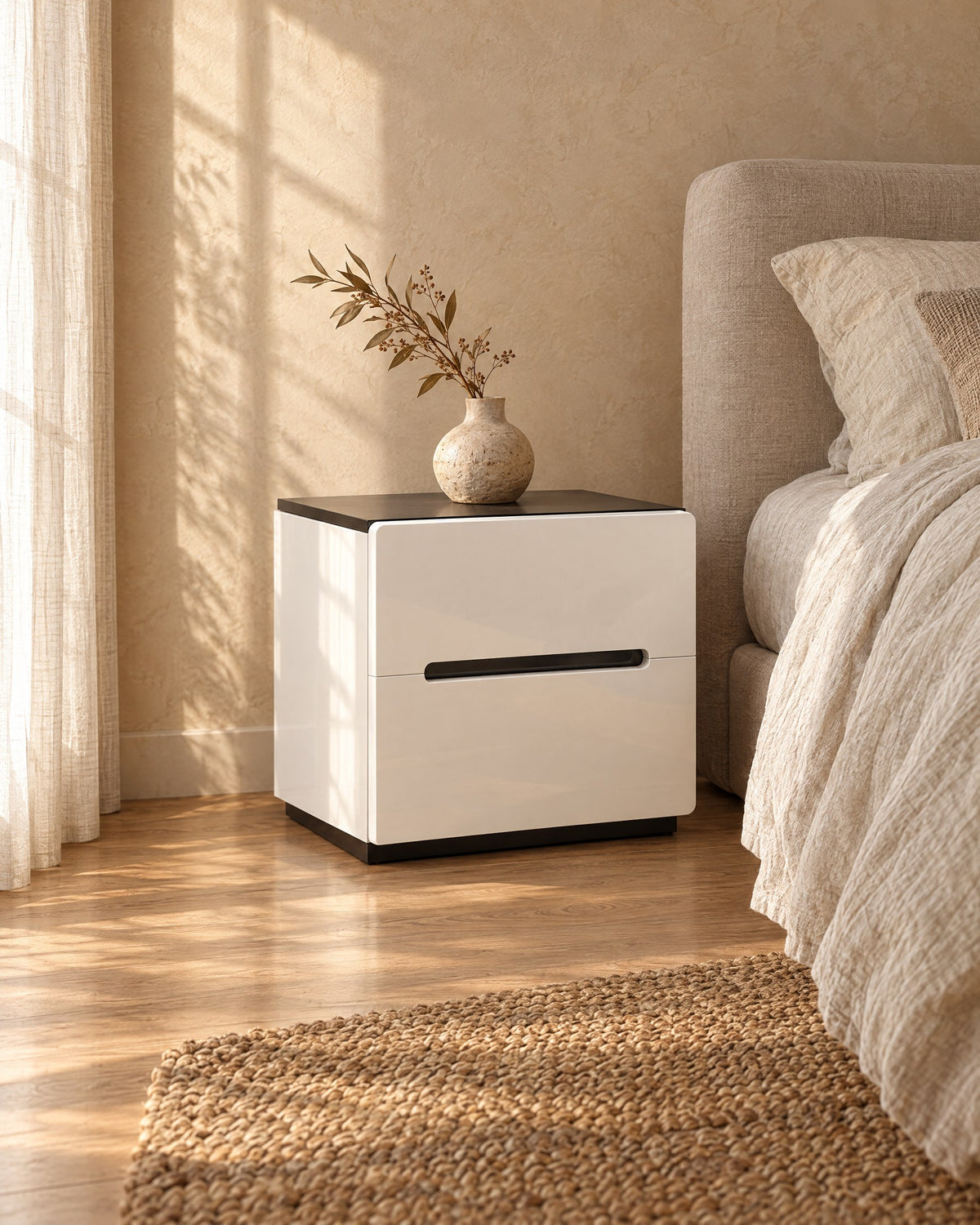 Three-quarter view of the white gloss bedside table with a black top