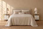 Pair of white bedside table with a gold frames either side of a double bed