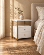 Three-quarter view of the white bedside table with a gold frame
