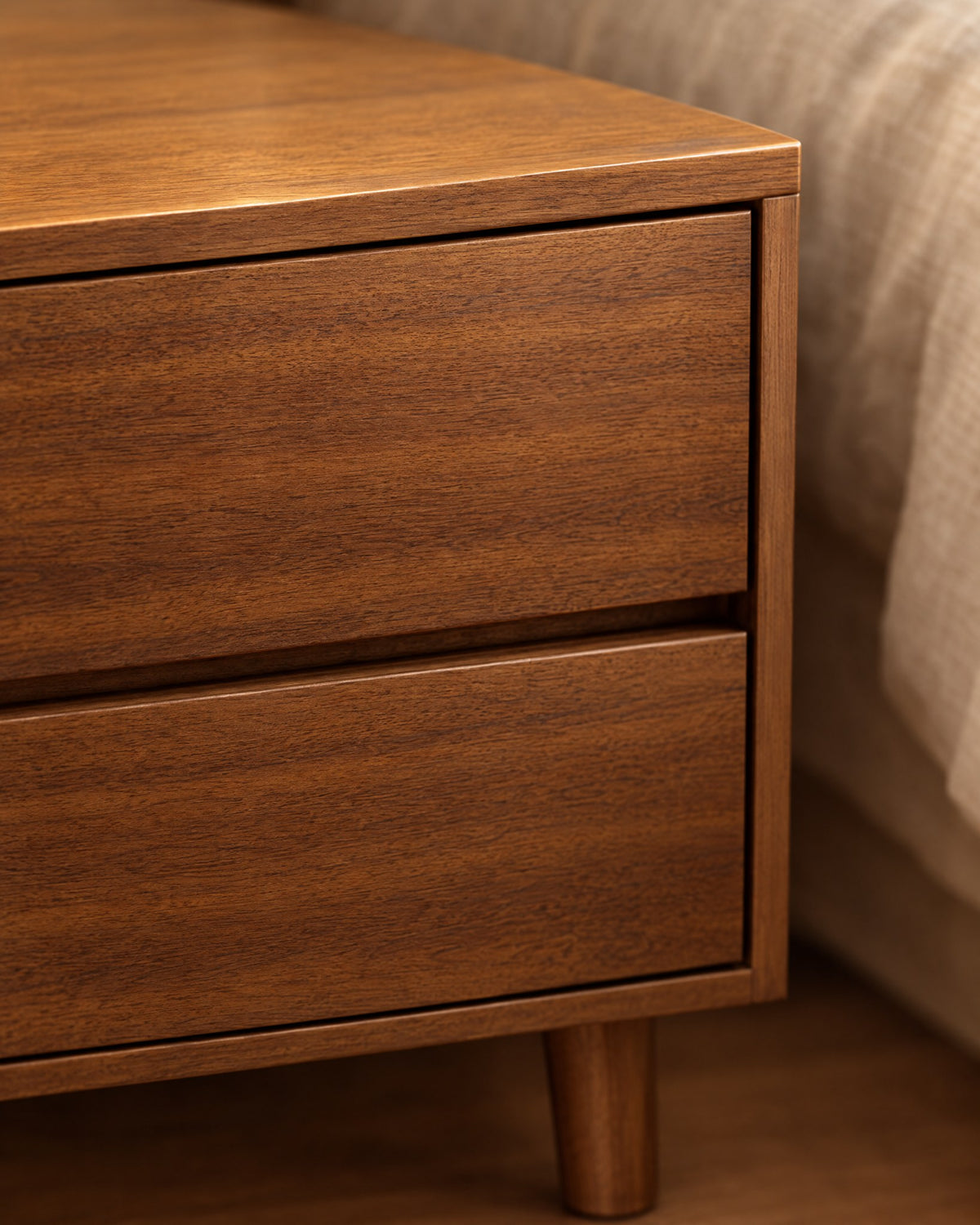 Close-up of the walnut-effect grain and the finger gap under the drawer
