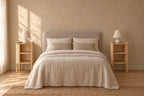 Pair of wooden cane bedside tables on each side of a double bed